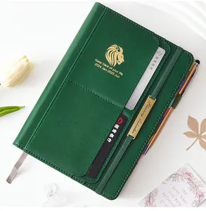 Macro detail of green faux leather 18-month 2024 planner showing card slots and pen loop.