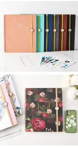 Detailed view of 2023 floral spiral planner with elastic band, stickers, and ruler