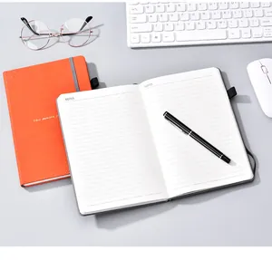 Close-up of open grey notebook with lined pages and business pen on office desk