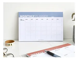 Detailed view of blue monthly planner notepad with date grid and priority section