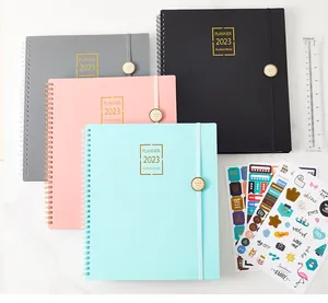 Detail view of 2023 weekly and monthly spiral planners in assorted colors with stickers