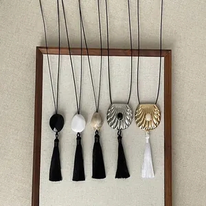 Zen-style tassel necklaces collection featuring unique shell and stone pendants.