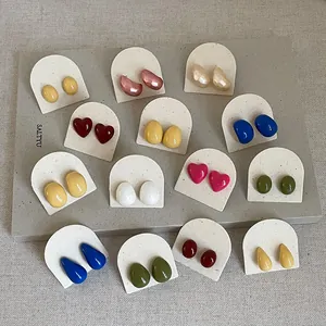 Detailed display of colorful drip oil heart and bean-shaped stud earrings in various colors