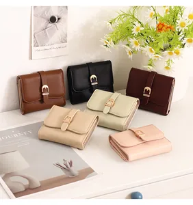 Collection of colorful short women's wallets featuring elegant belt buckle metal closures.