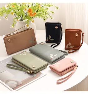 Variety of elegant women's PU leather wallets with floral prints and wristlet straps.