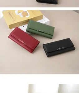 Minimalist women's long wallets in red, green, and black leather with metal accents.