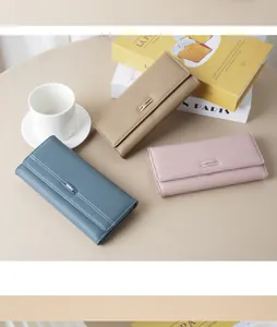 Set of elegant long wallets in blue, khaki, and pink with a minimalist metal clasp
