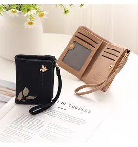 Detailed view of the small floral wallet showing internal card slots and coin pocket