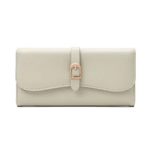 Front design detail of a beige long wallet with rose gold buckle and pebble texture