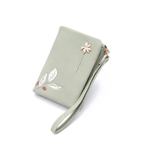 Detailed view of fresh floral short wallet with embroidery and golden flower charm