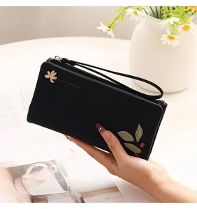 Elegant black PU leather women's long wallet with floral print and wristlet strap.