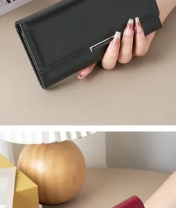 Detailed shot of a sleek black women's long wallet with silver metallic accent