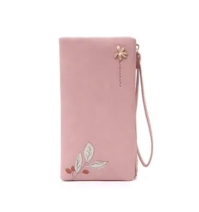 Detailed view of an elegant pink PU leather long wallet with leaf print and gold ornament