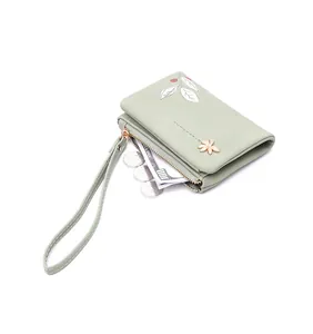 Mint green floral print short wallet with wrist strap and gold flower clasp detail