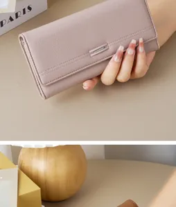 Detailed view of an elegant mauve textured leather long wallet for women with metal clasp