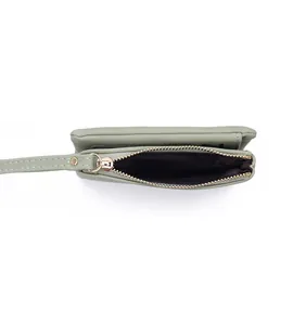 Detailed interior view of a light green faux leather coin purse with zipper closure