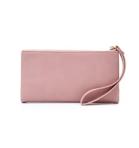 Front view of a dusty pink PU leather long wallet with wrist strap and gold zipper