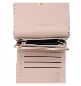Detail view of the interior compartments of a compact taupe faux leather wallet