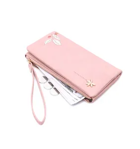 Detailed view of pink long wallet showing banknotes and coins for high capacity storage.