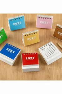 Detailed view of mini 2027 desk calendars in multiple vibrant colors with spiral binding