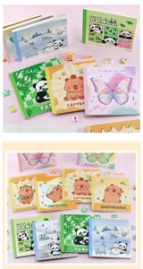 Detailed view of cute cartoon grid notebooks featuring panda and capybara designs
