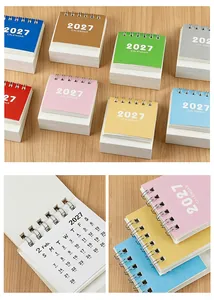 Close-up details of 2027 mini desk calendar pages and multi-color spiral binding