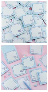 Close-up of cute cartoon white bear memo pads with grid patterns and sports motifs.