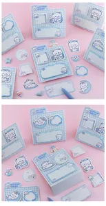 Close-up macro view of kawaii blue bear memo pads and sticky notes on pink background
