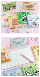 Detail of cute cartoon panda and capybara grid notebooks with smooth writing paper