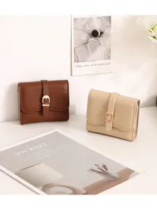 Elegant women's short wallet with belt buckle closure and pebble grain texture