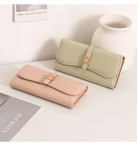 Detailed view of elegant textured leather long wallets in pastel pink and sage green