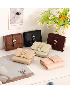 Elegant women's short wallets featuring decorative belt buckle in various colors.