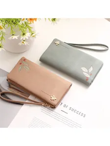 Elegant long PU leather women's wallet with floral print, charm, and wristlet strap.