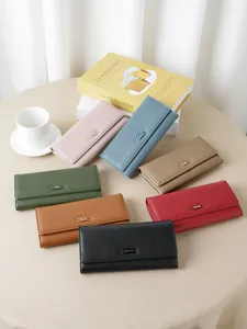 Fashionable multi-color long leather wallets for women featured in a stylish lifestyle arrangement