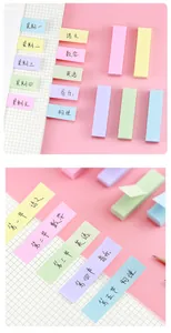 Close-up view of colorful Morandi sticky notes used for organization on a notebook.