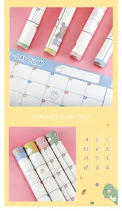 Close-up of colorful cute monthly plan sheets and rolled-up calendars with cartoon designs