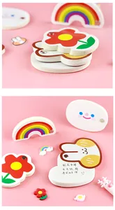 Detailed view of cute cartoon-shaped mini memo pads with rainbow and flower designs