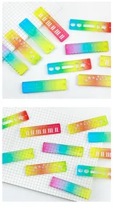 Close-up of mini rainbow transparent rulers featuring scales, angles and piano patterns