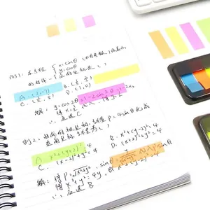 Colorful translucent neon index tabs set applied to a notebook for organization and study