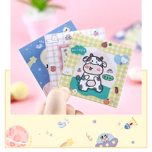 Detailed macro view of various cute cartoon animal sticky notes featuring cow designs.