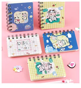 Collection of cute cartoon cow mini spiral notebooks in various pastel colors and patterns