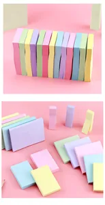 Macro view of multi-colored Morandi sticky note pads for office organizing and school use.