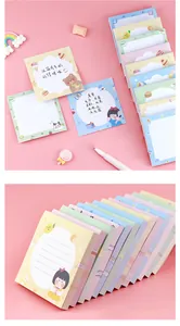 Detailed view of cute cartoon sticky notes with grid and lined patterns for students.