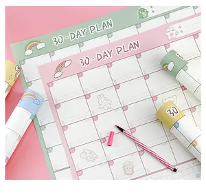 Detailed close-up of cute 30-day monthly plan sheets with pastel illustrations