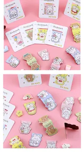 Close-up of cute cartoon magnetic bookmarks featuring diverse animal patterns on pink background