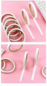 Close-up detail view of thin white double-sided adhesive tape rolls for school handcrafts