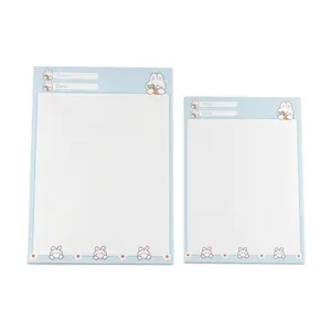 Set of two cute cartoon rabbit memo pads with grid paper design in light blue color