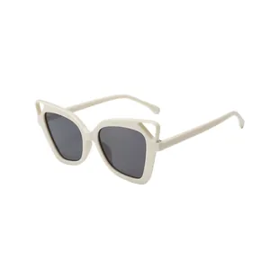 Trendy hollowed-out cat-ear sunglasses with beige oversized frames and grey lenses