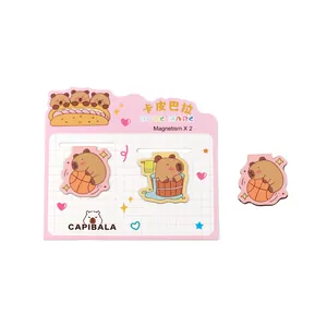Adorable set of two cartoon capybara magnetic bookmarks on a pink decorative grid card