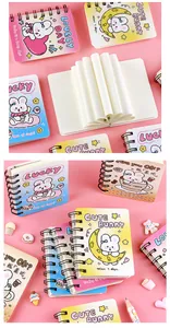 Close-up detail of A7 colorful gradient spiral notebooks featuring cute cartoon rabbit designs